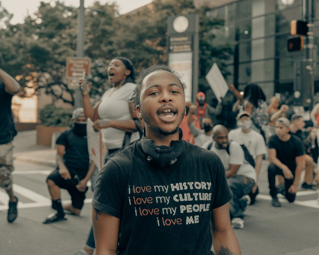 A man in black shirt standing next to crowd.