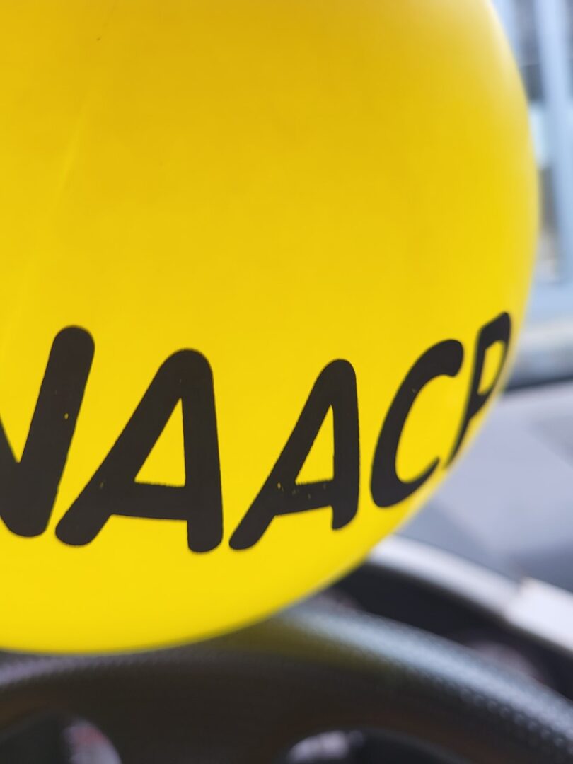 A yellow balloon with naacp written on it.